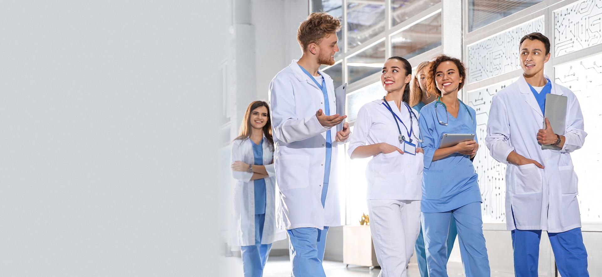 Grupa lekarzy rozmawiająca na korytarzu