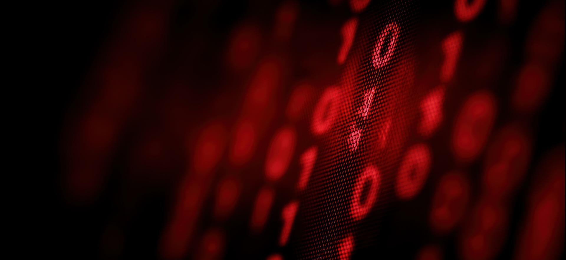 czerwone zera i jedynki w rzędach ustawionych pod skosem na czarnym tle